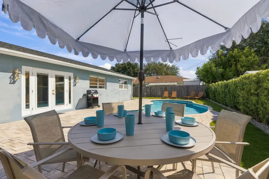 Poolside dining table under an umbrella