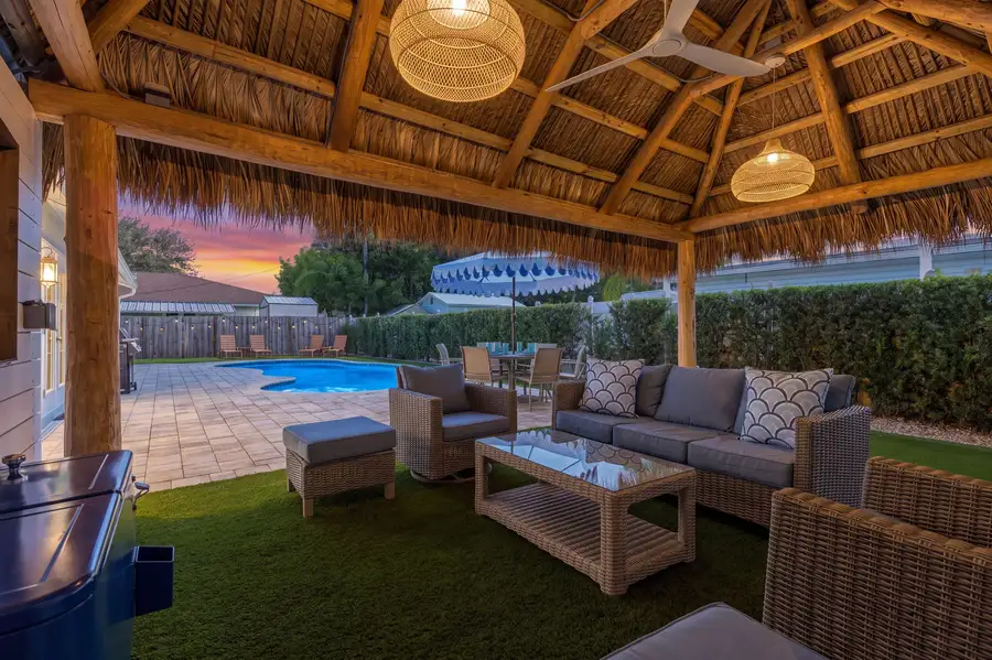 Thatched tiki hut with lounge seating